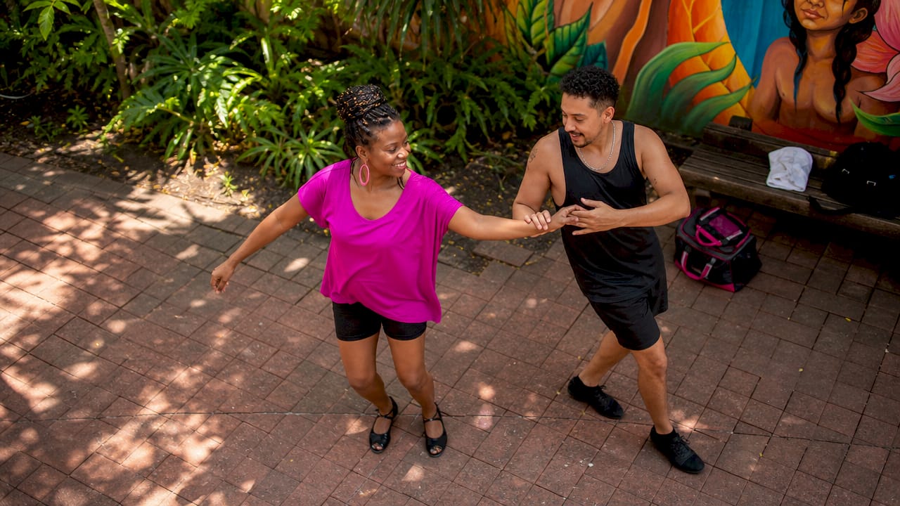 Woman leading partner rotation in dance class