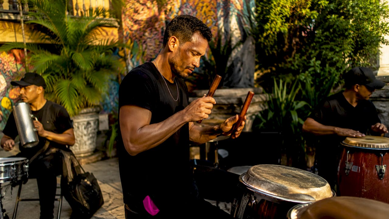 Percussionist playing claves in rehearsal room