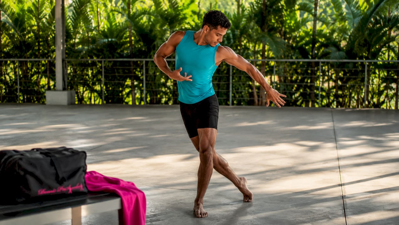 Close-up of dancer's hands and feet moving on floor