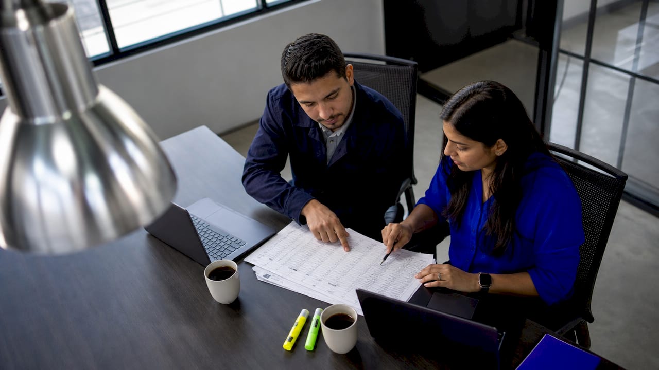 Engineers creating asset register at workbench