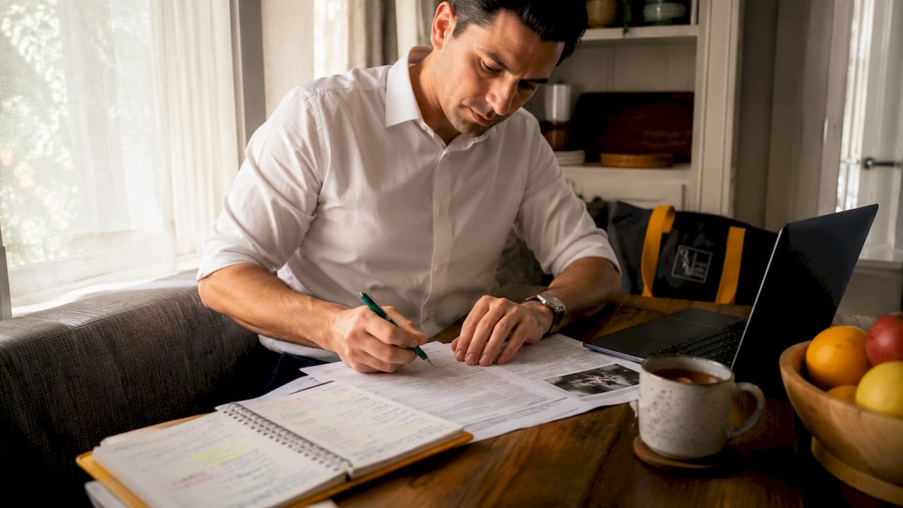 Hands filling car accident injury claim forms