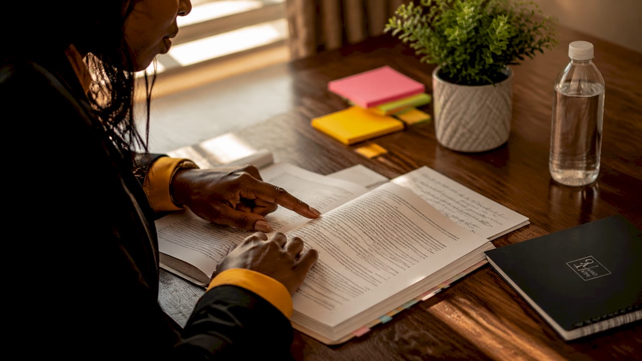 Overhead of hands pointing to negligence law booklet