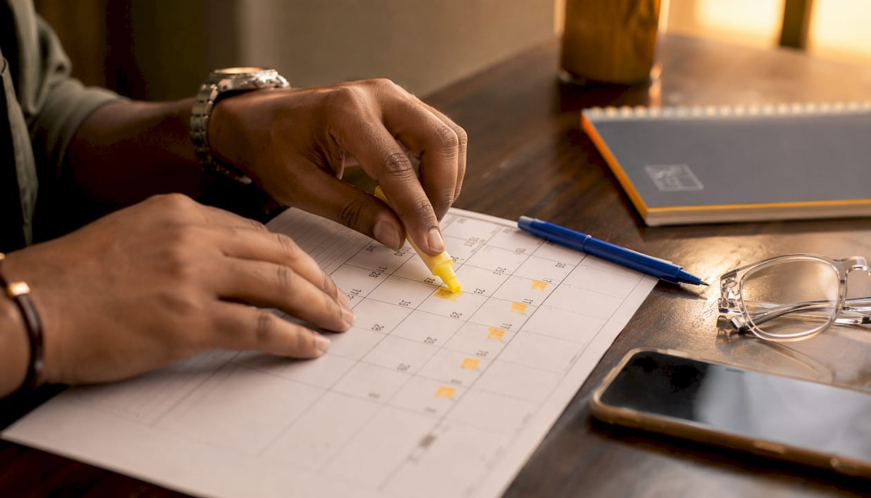Hands marking legal claim deadline on calendar