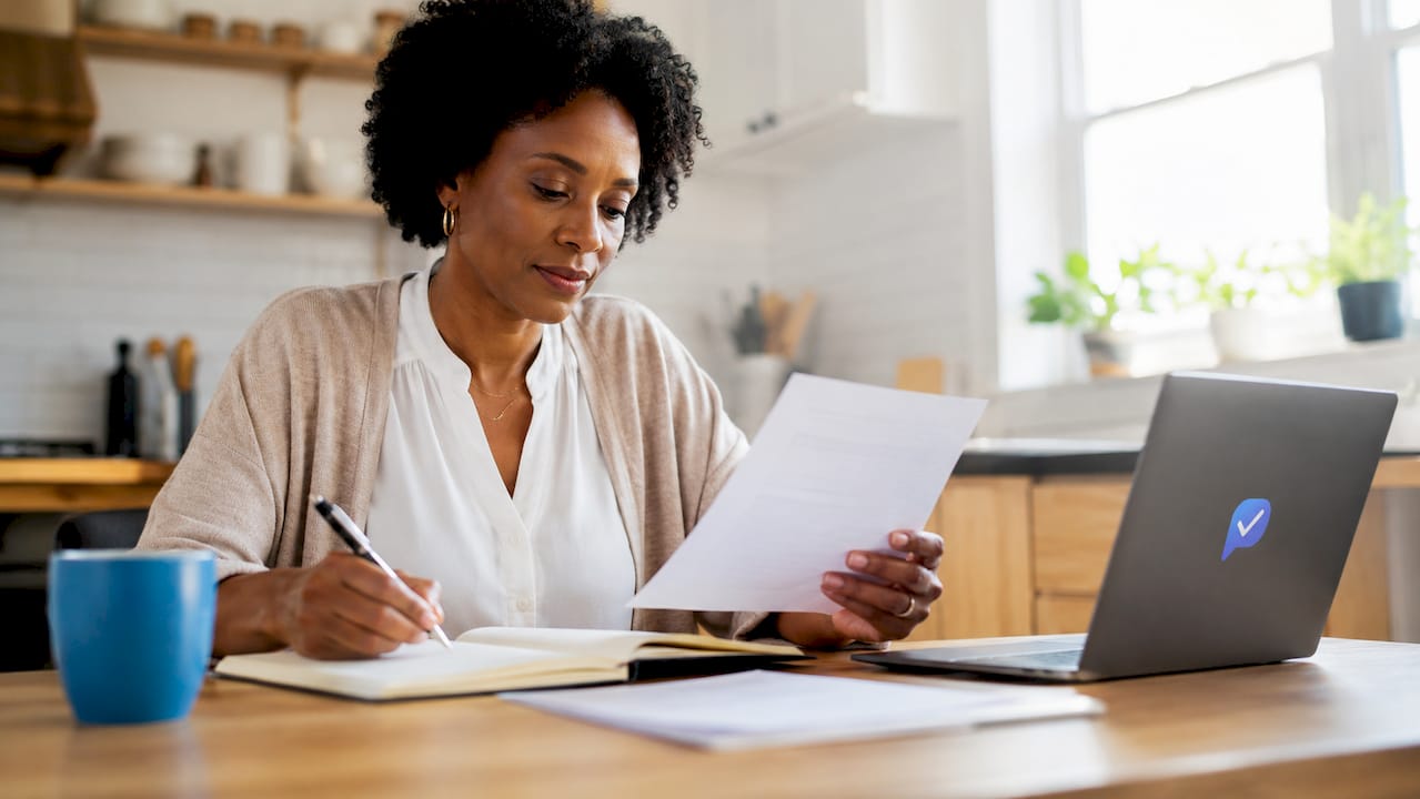 Woman defining job role competencies at desk