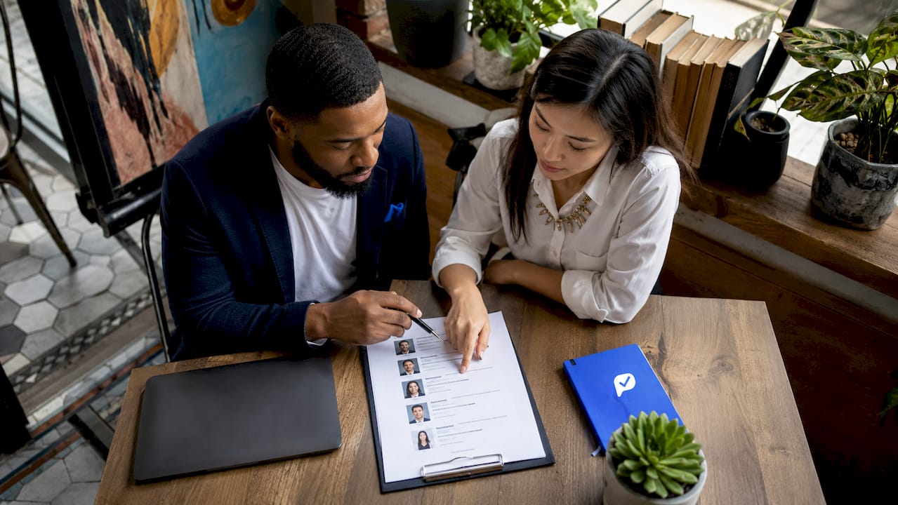Two recruiters reviewing candidate shortlist together