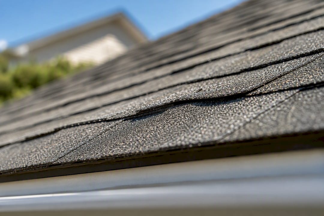 Raised shingle tab showing a nail pop
