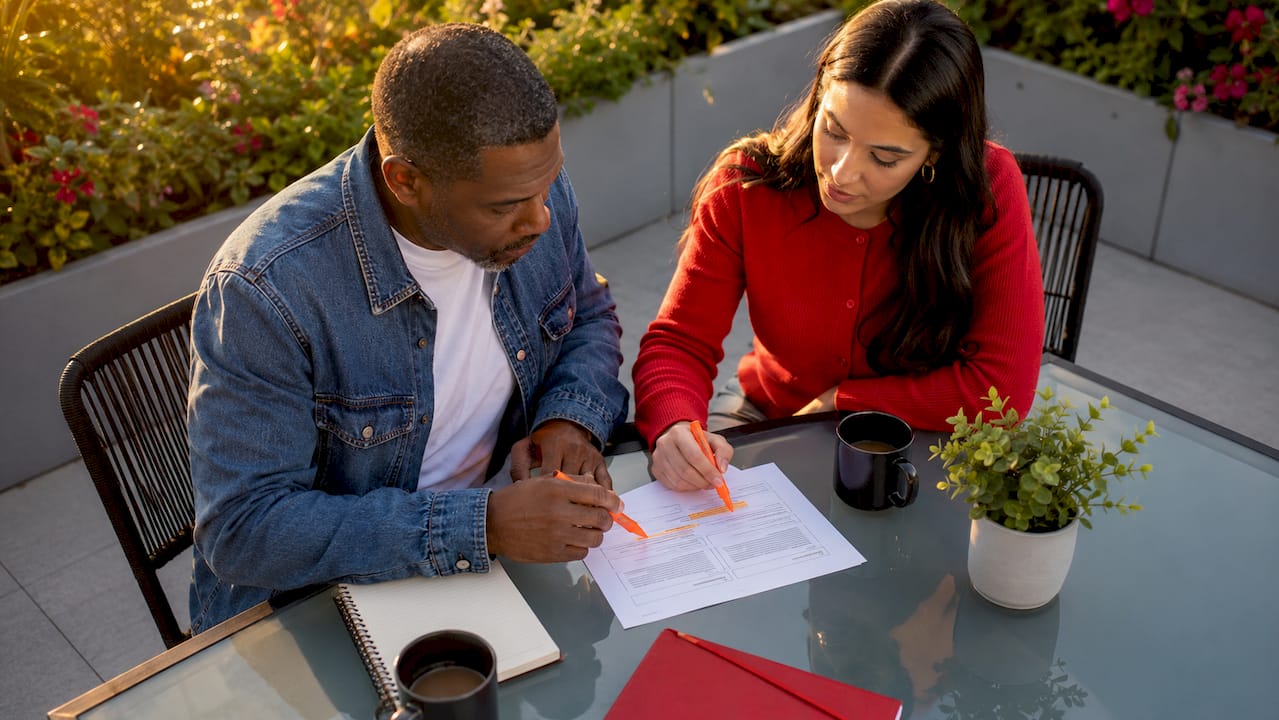 Two colleagues discussing value proposition document