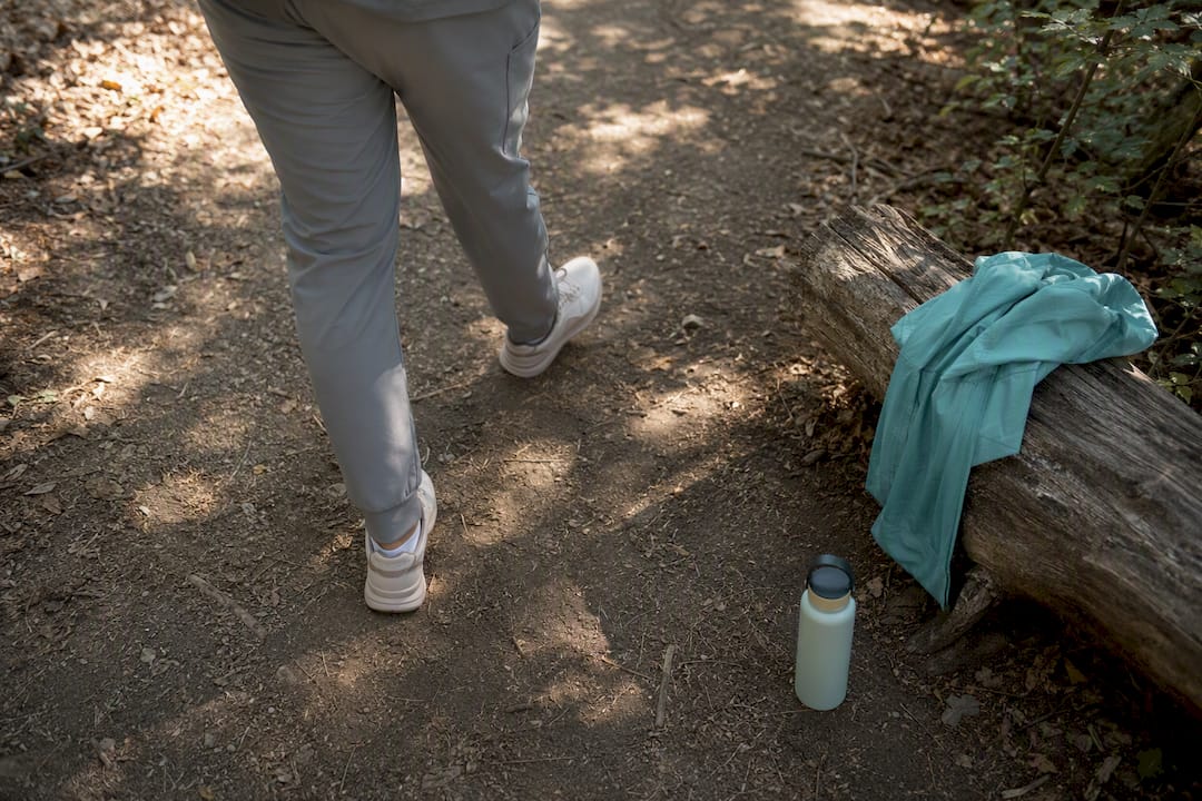 Legs walking on park path after meal