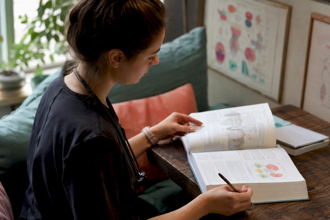 Nurse reading functional medicine textbook