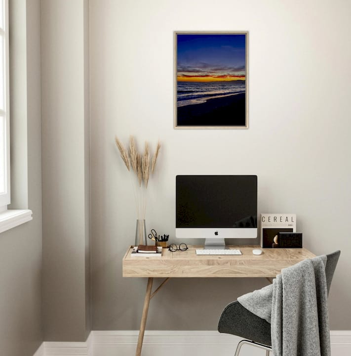 Hands placing personalized art print on wall