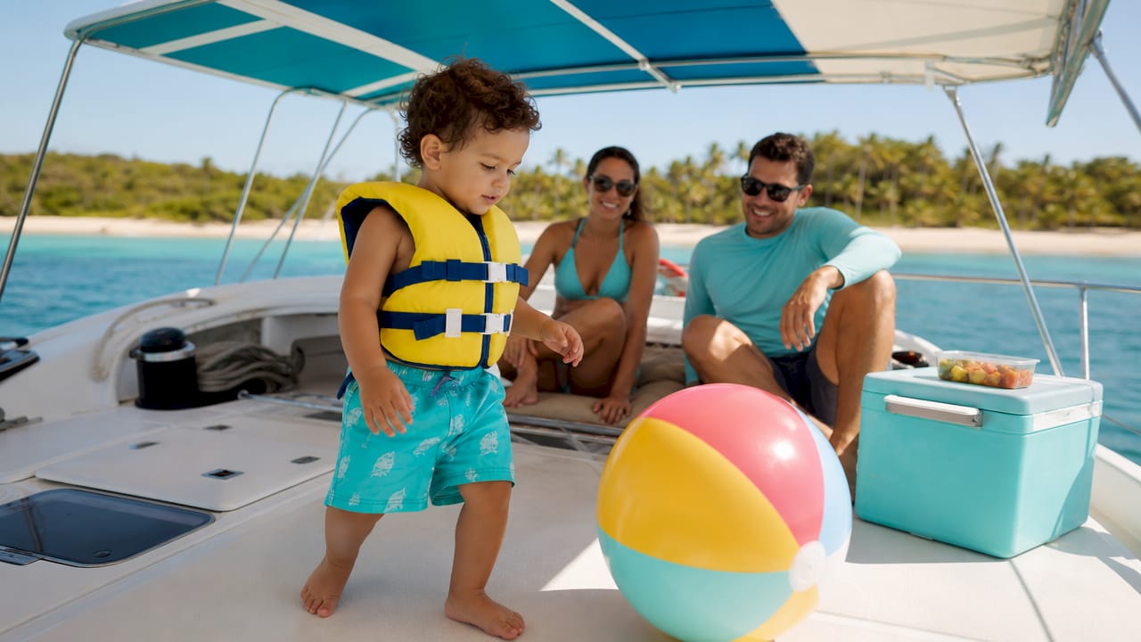 Toddler exploring stable pontoon boat with parents