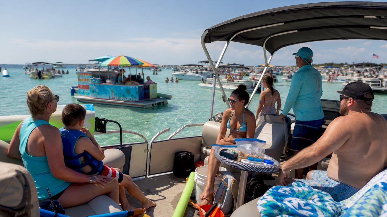 Pontoon boat anchored at lively Crab Island sandbar