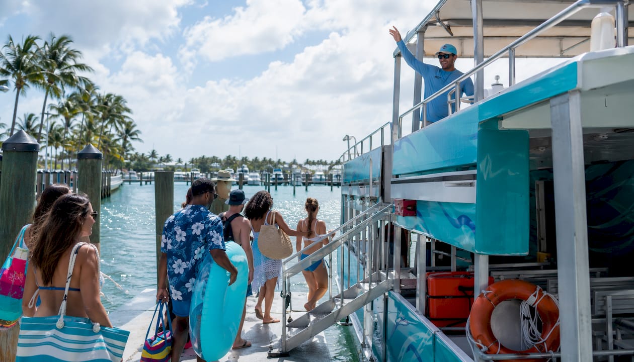 Group boarding budget-friendly Crab Island tour boat