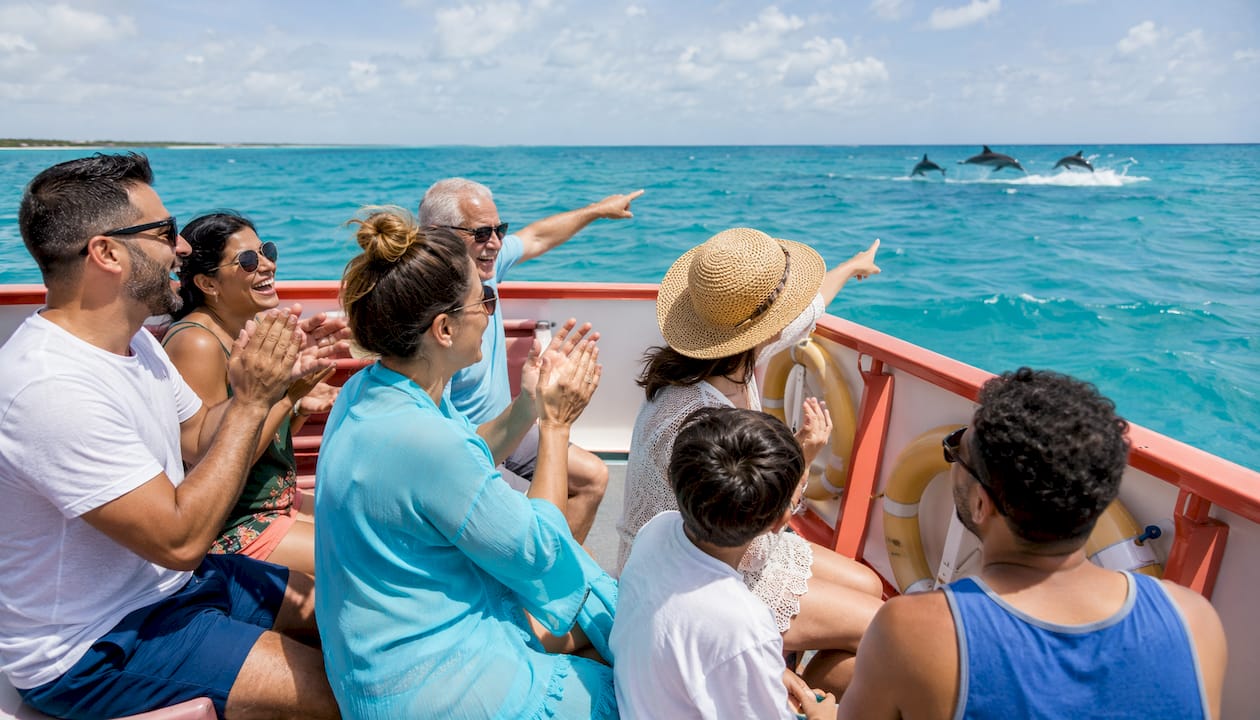 Group of passengers enjoying social moments on boat tour