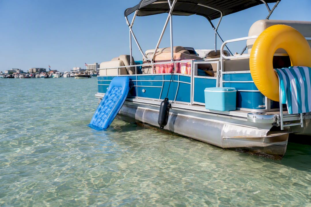 Empty pontoon boat floating on clear turquoise water