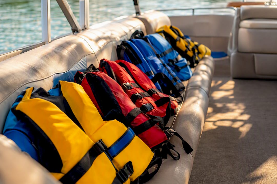 Assorted life jackets on pontoon boat seats
