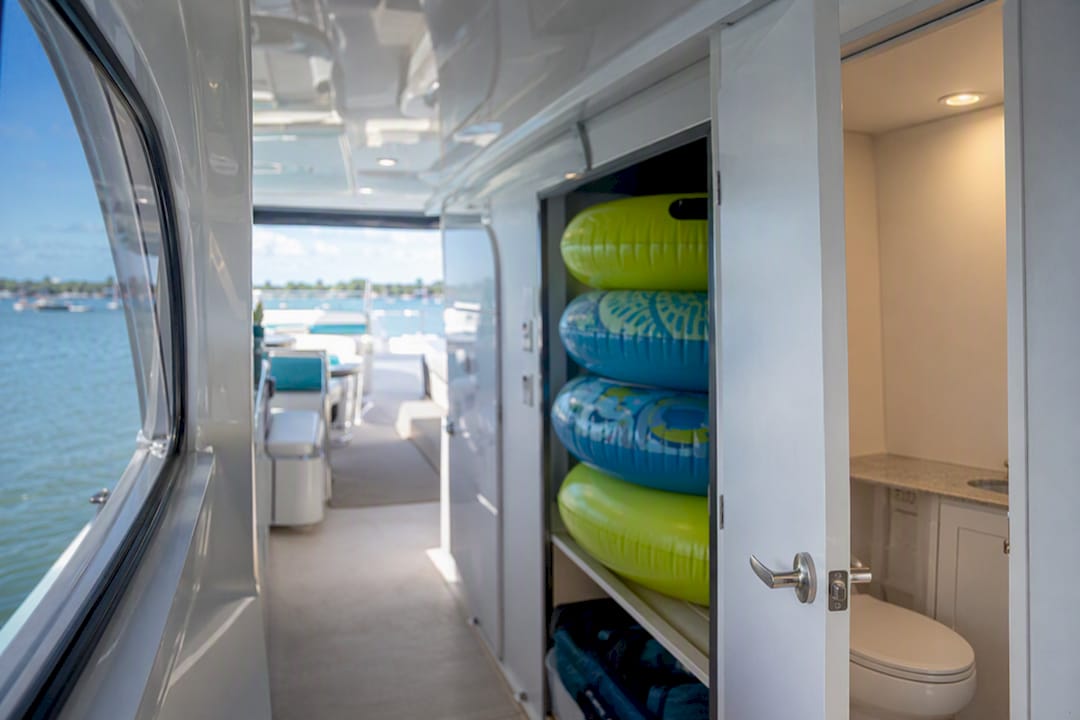Pontoon boat restroom door and stacked floats onboard