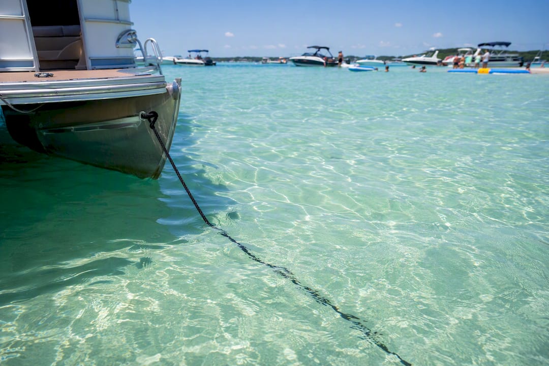 Pontoon boat anchored near Crab Island sandbar