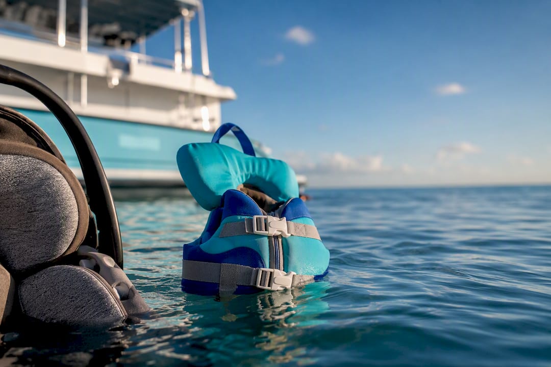 Infant life jacket floating beside car seat