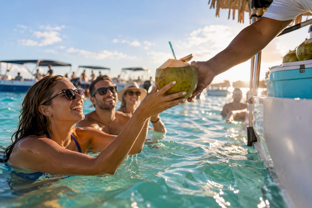 Fresh coconut handed across Crab Island water