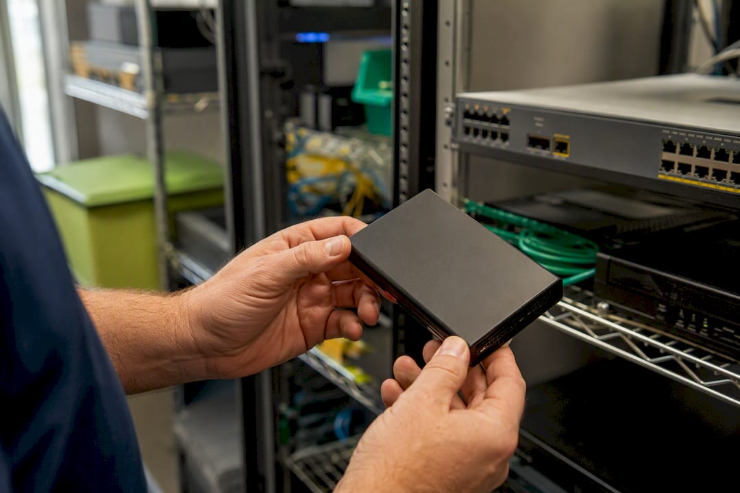Hands inspecting encrypted backup device