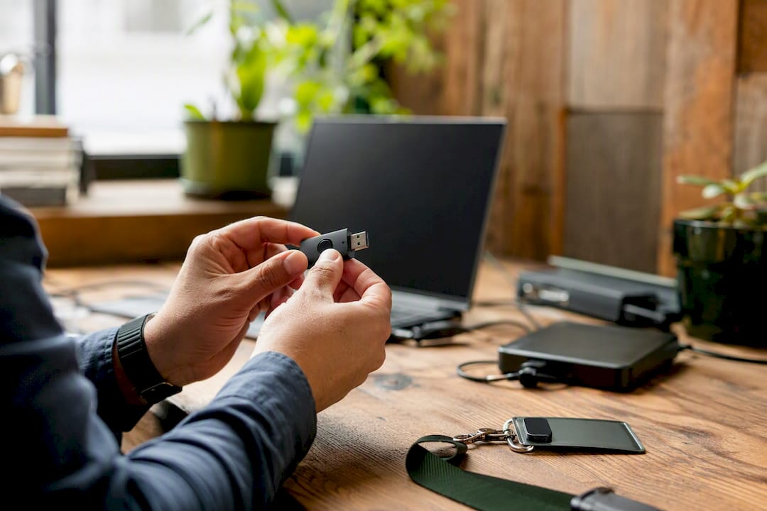 Hands inspecting USB device for compliance