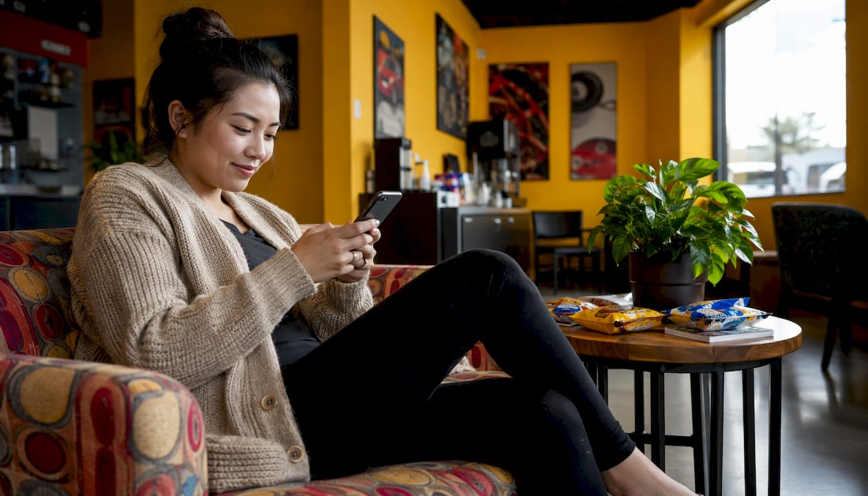 Woman waiting comfortably in oil change lobby