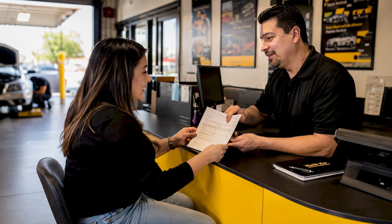 Customer reviewing written repair estimate with advisor