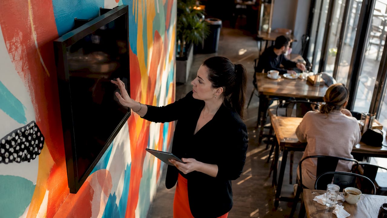 Restaurant manager updating digital signage content