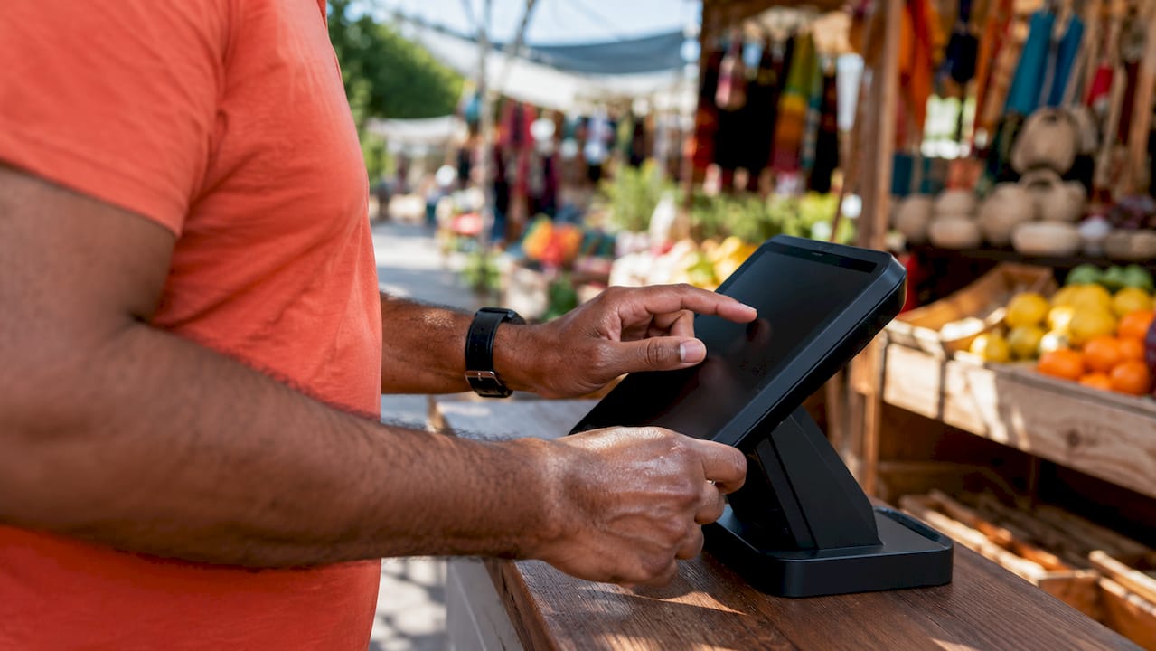 Hands using POS terminal near bar counter