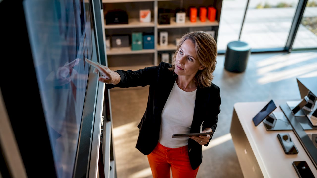 Store manager adjusting retail promotional screen