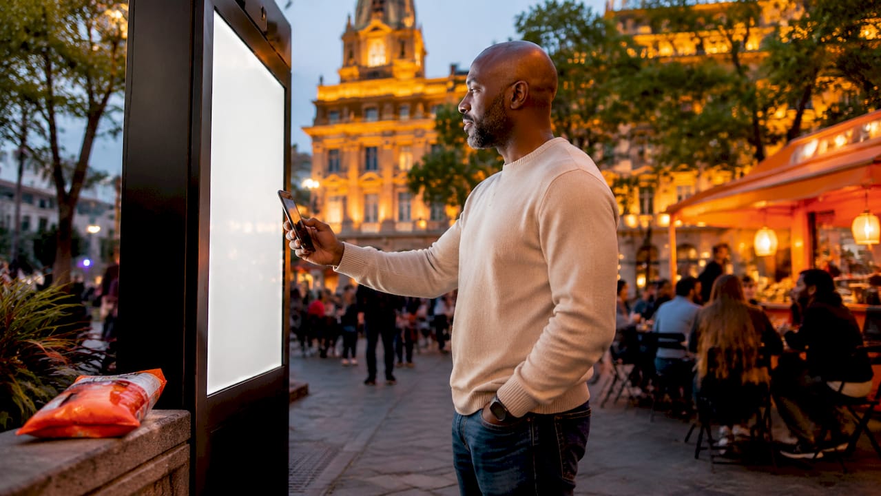 Man interacting with outdoor tourism digital screen