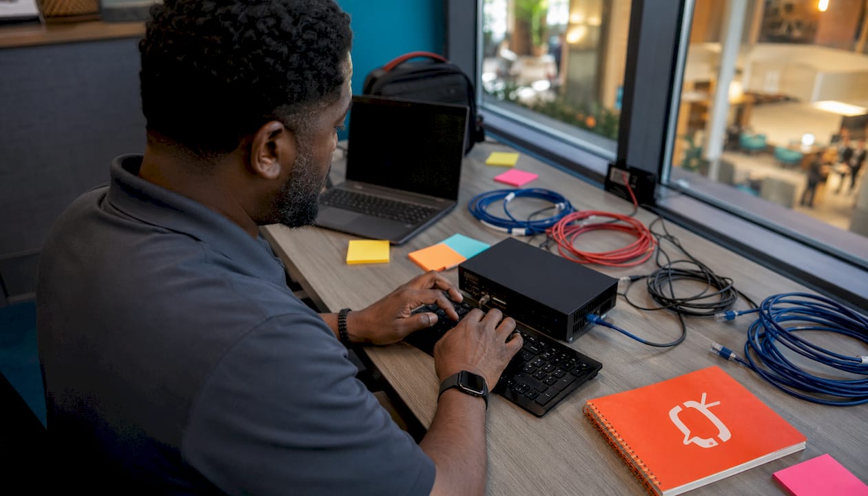 Technician configuring hospitality screen hardware