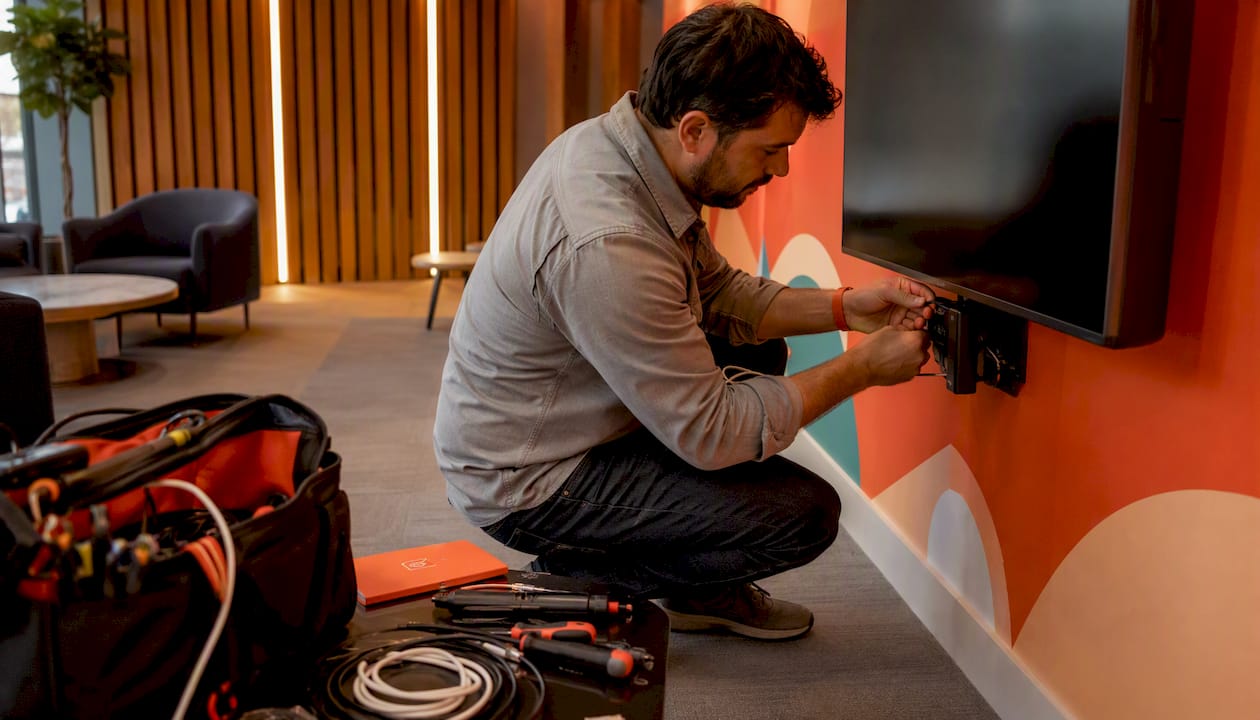 Technician installing streaming device on smart TV