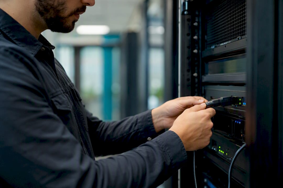 Hands connecting diagnostic cable to signage device