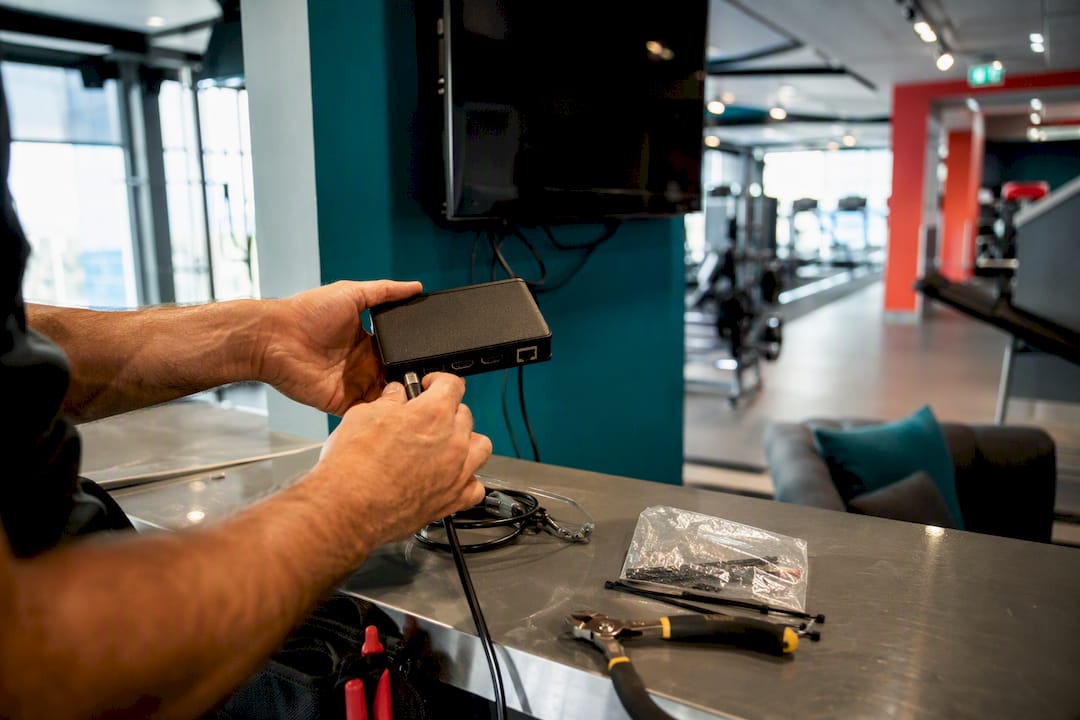 Technician connecting digital signage device