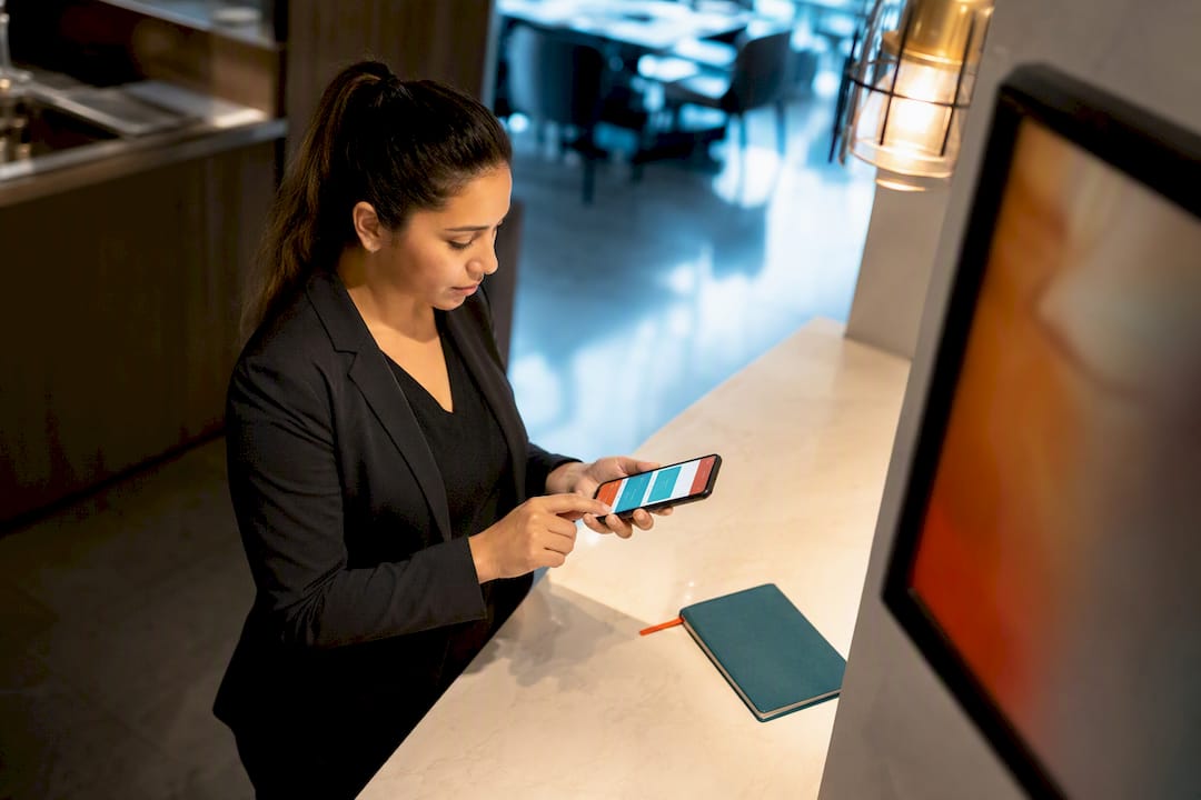 Restaurant manager updating signage by phone