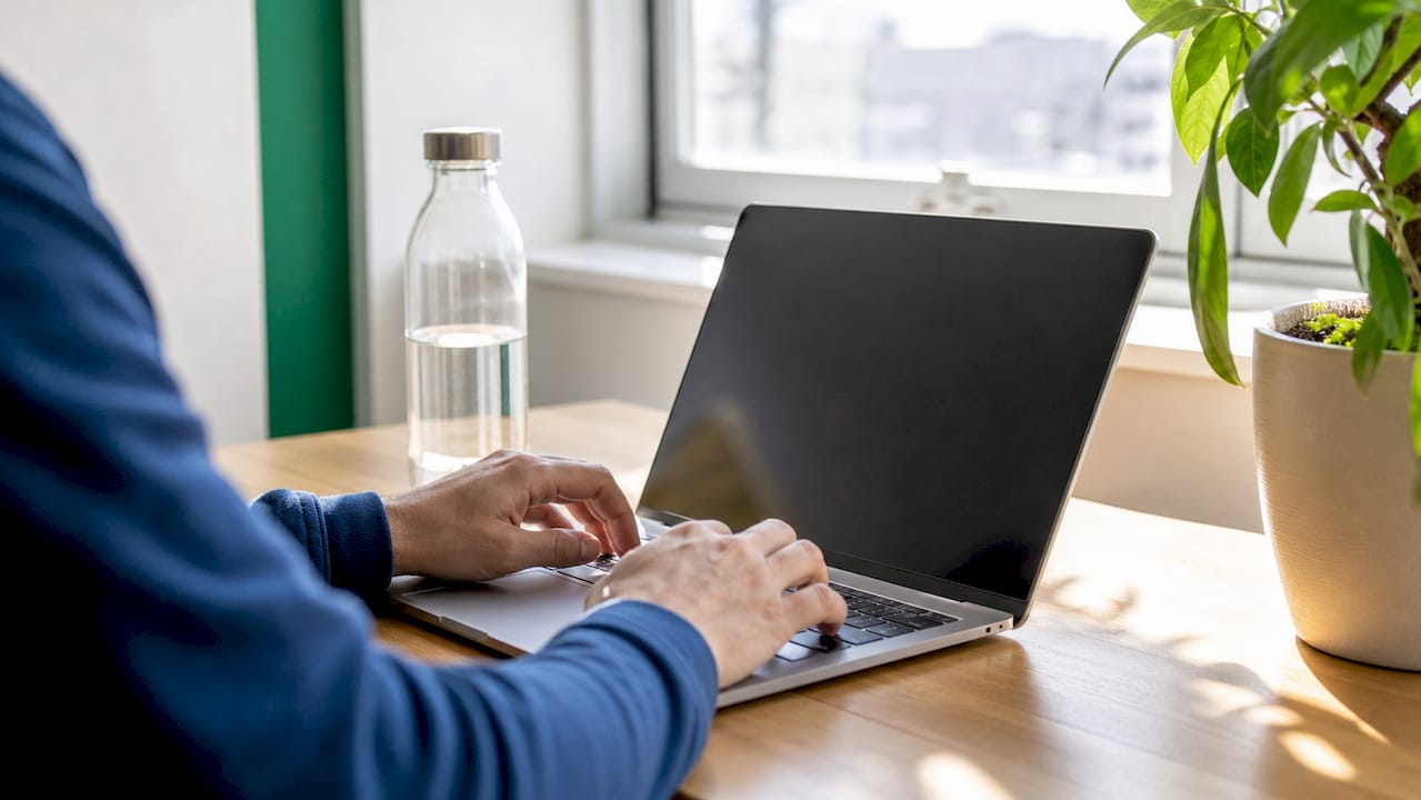 Close-up of hands typing in office environment