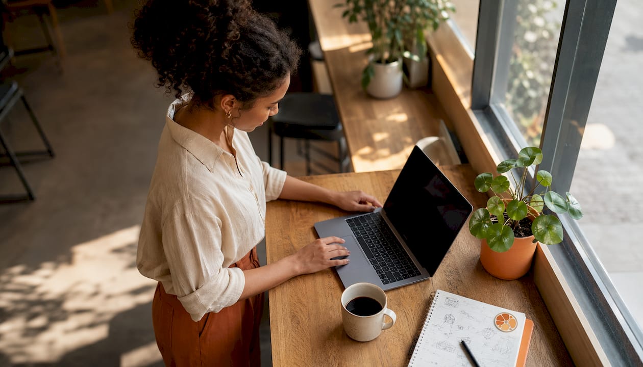 Employee configuring auto-response software at workstation
