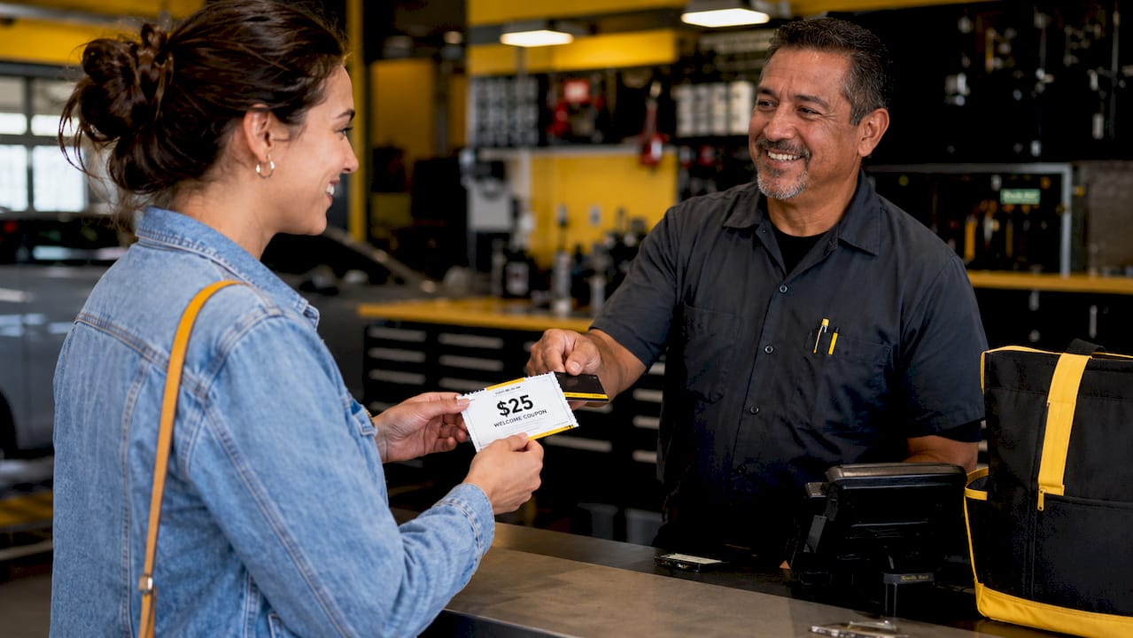 Hands exchanging loyalty card and welcome coupon