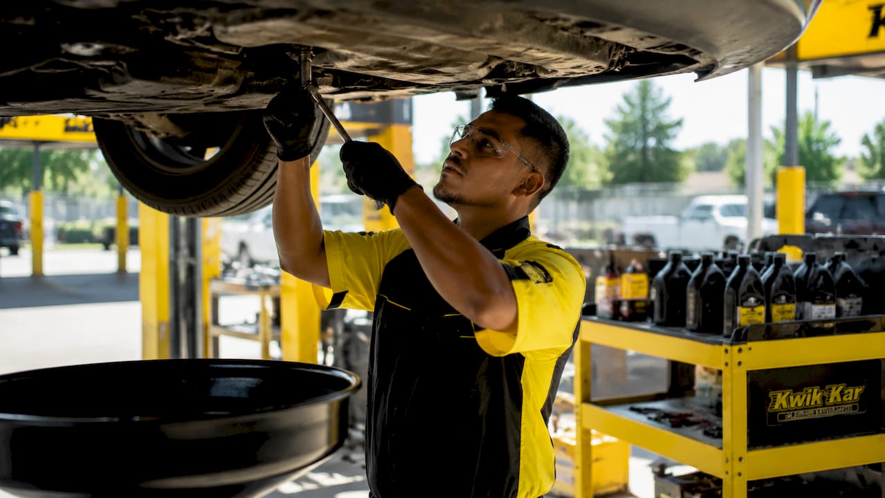 Technician performing oil change service