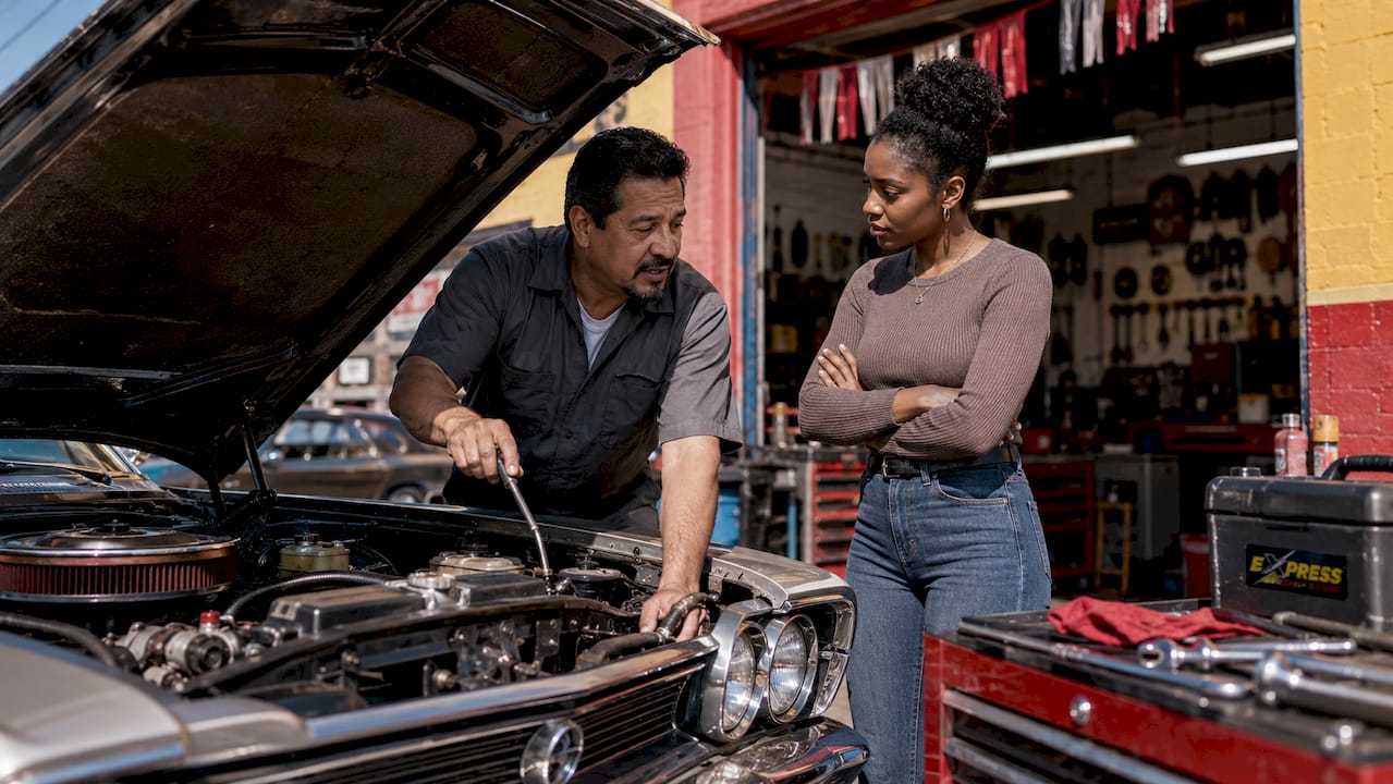 Mechanic discussing car service with customers