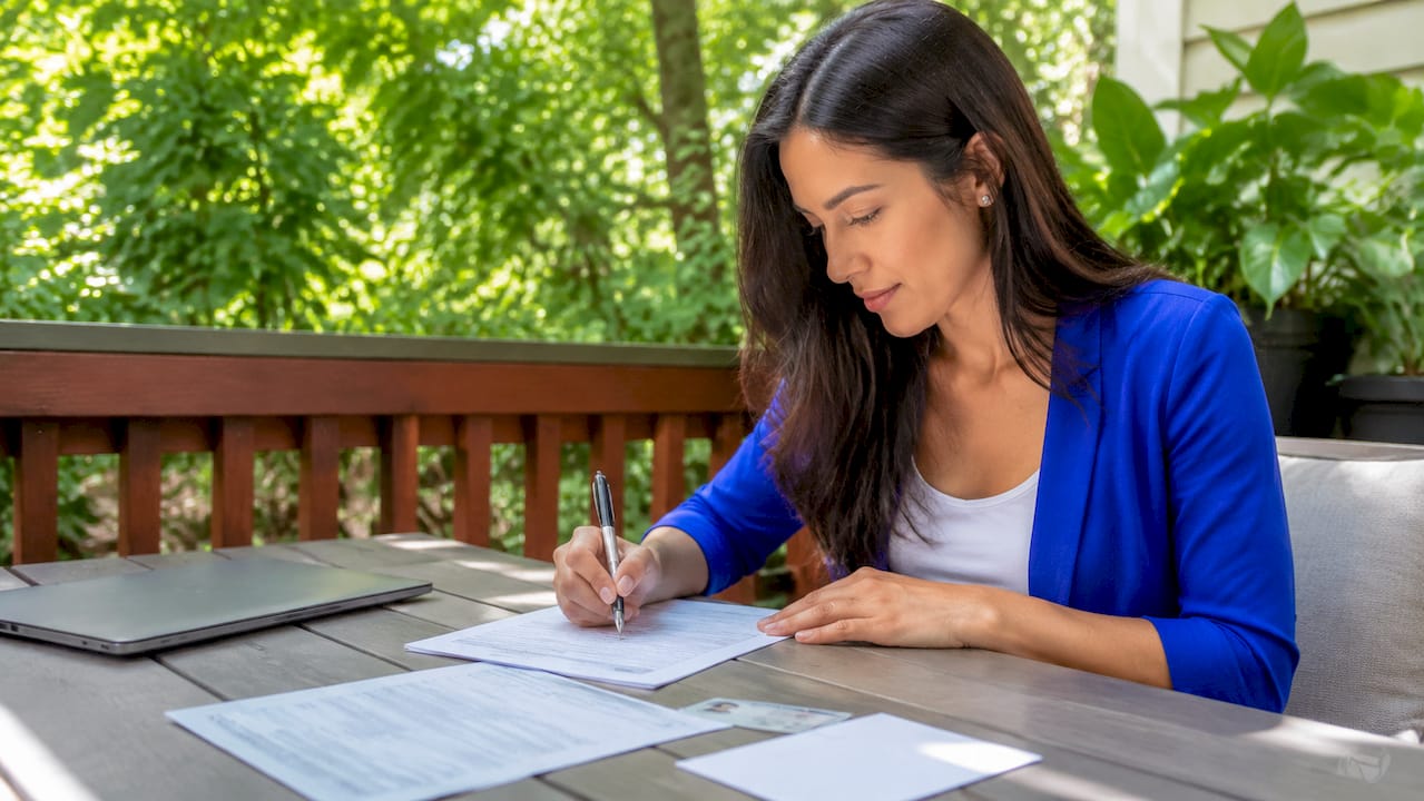 Tenant filling out rental application form