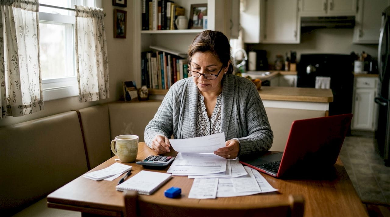 Landlord organizing rental expense documents at table