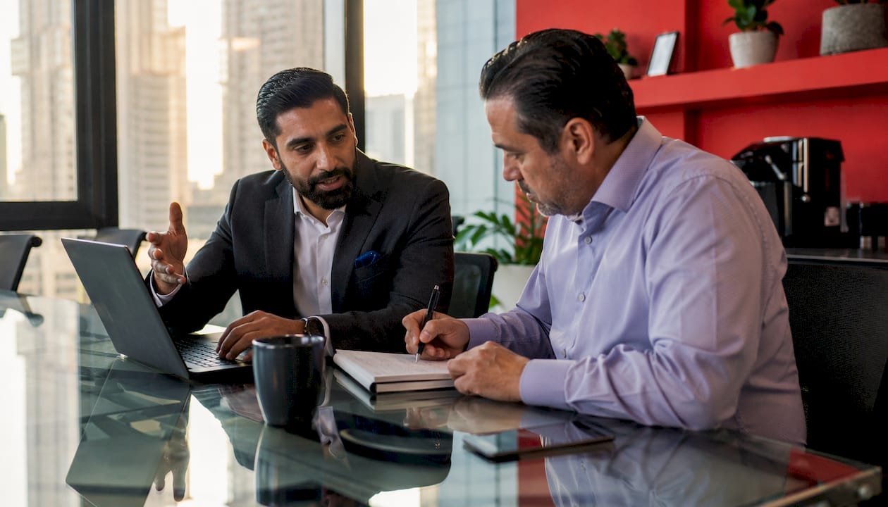 Overhead view of two professionals discussing LLC structure