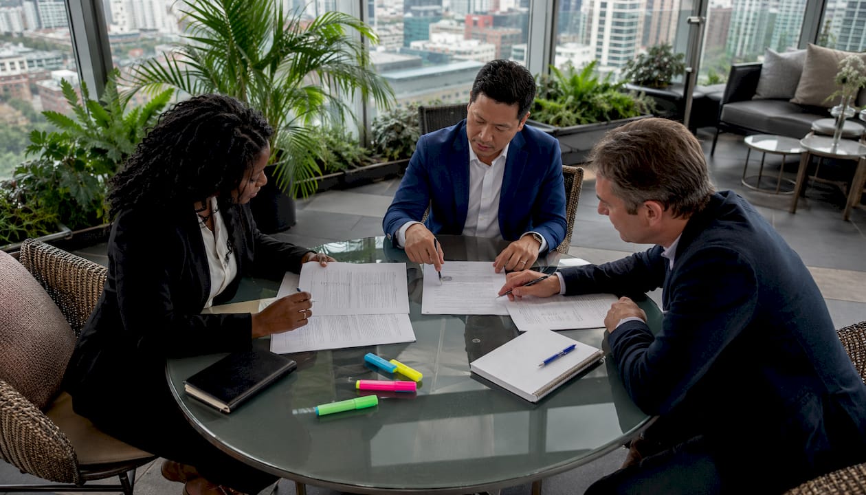 Group reviewing real estate partnership documents