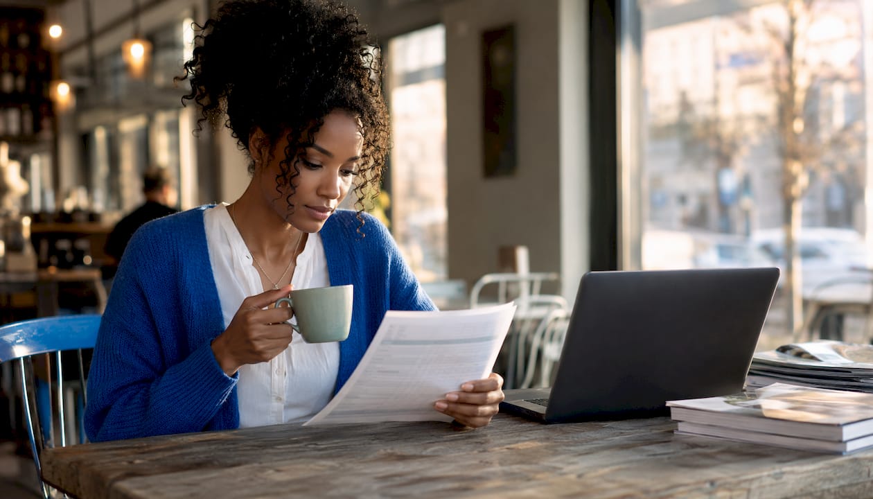 Woman reviewing investment loan details at home