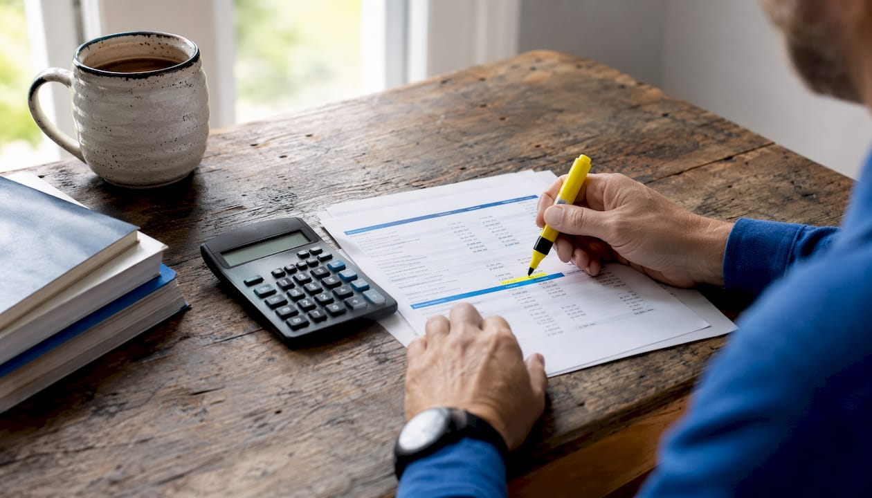 Hands analyzing investment cash flow documents