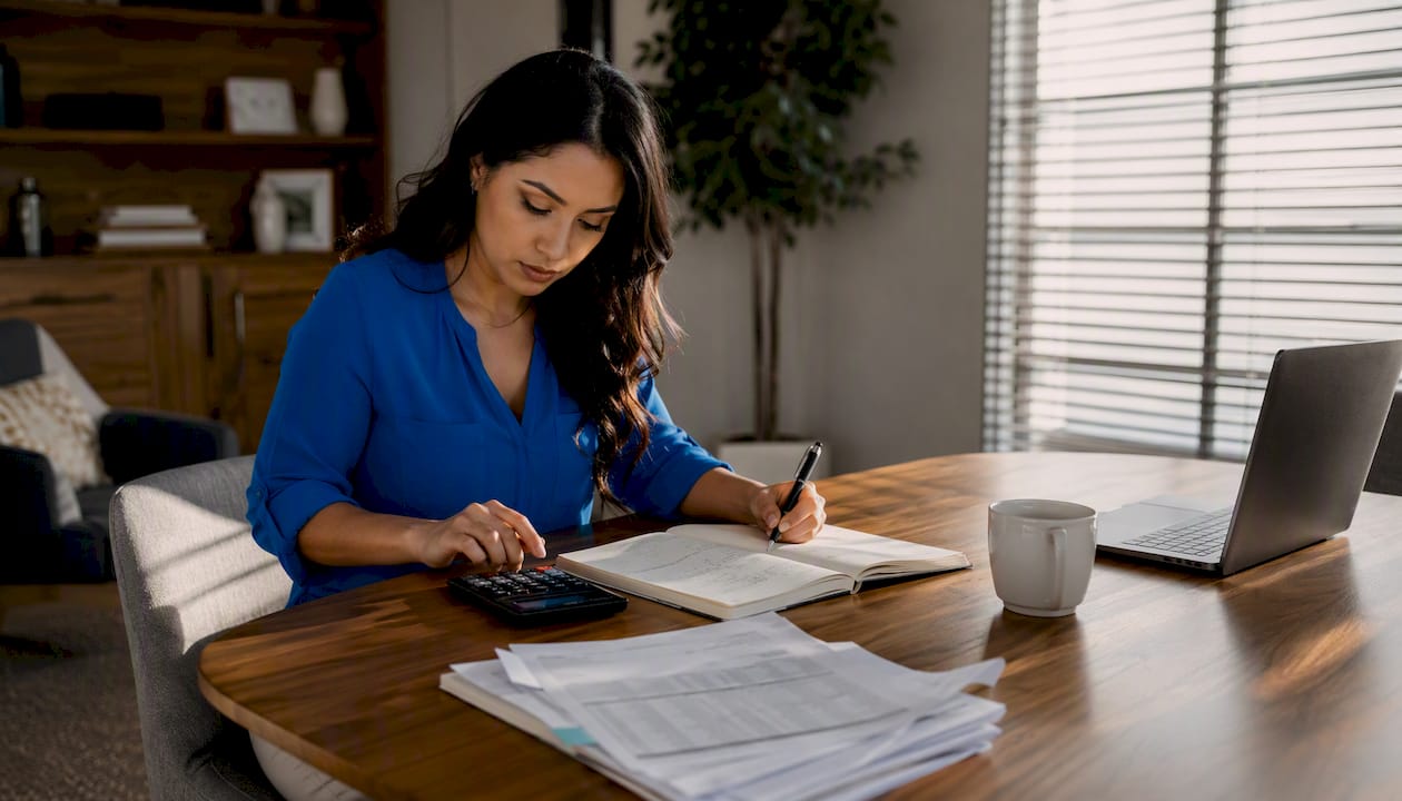 Hands calculating real estate financial metrics