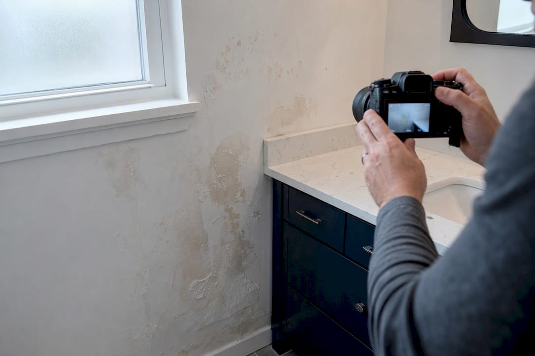 Landlord photographing rental damage details